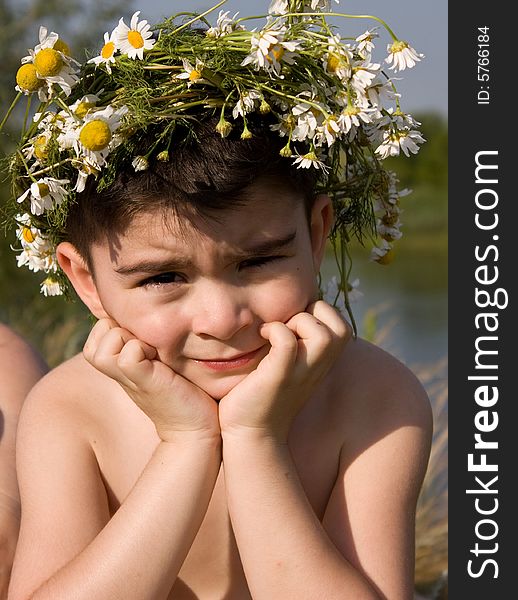 Pensive boy in wreath from daisywheel