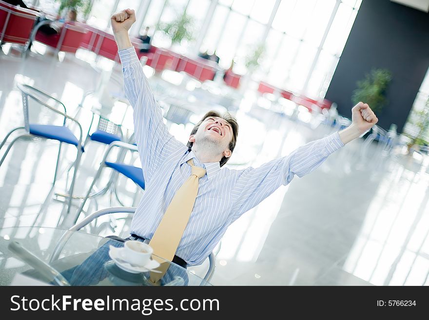 Young Happy Man At The Table