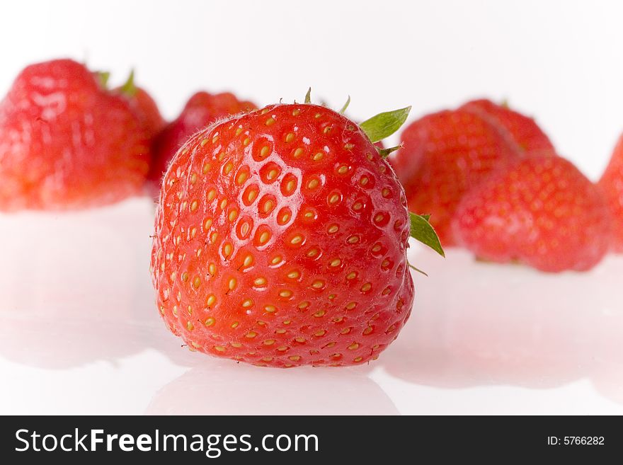 Few strawberries on white ground