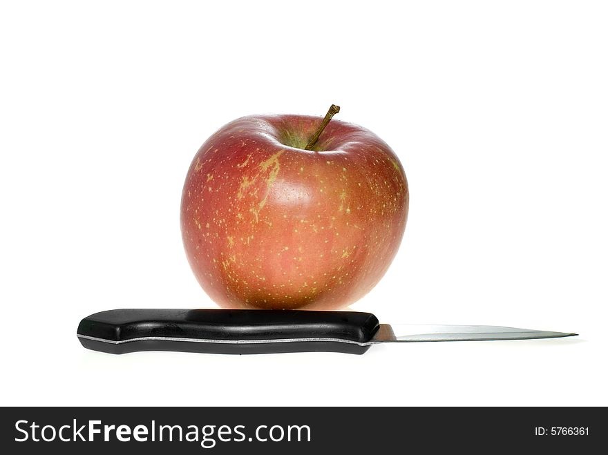 Red apple and small steel knife isolated on the white background