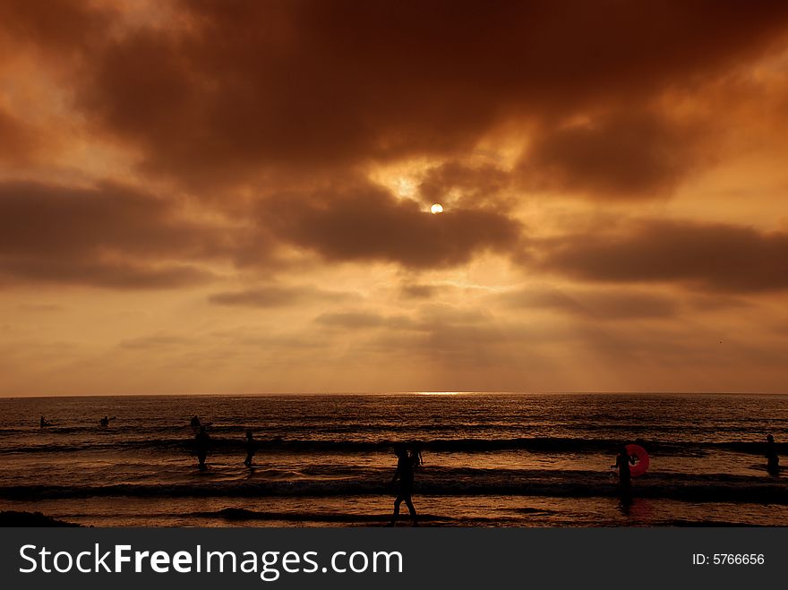 Orange Sunset With Beach Goers