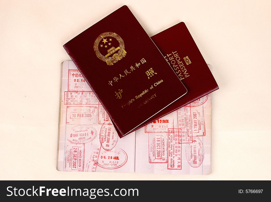 Chinese passport, European Union passport and one more open passport full of stamps. Chinese passport, European Union passport and one more open passport full of stamps.