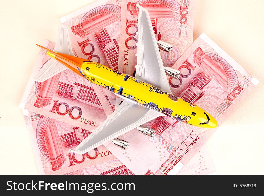 Travel to China... Chinese RMB banknotes and small plane. Travel to China... Chinese RMB banknotes and small plane.