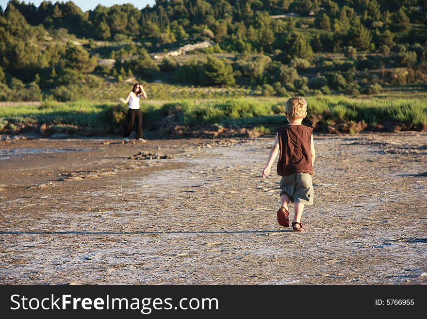 Child running towards his mother in
vineyard country,in the mediterranean. Child running towards his mother in
vineyard country,in the mediterranean.