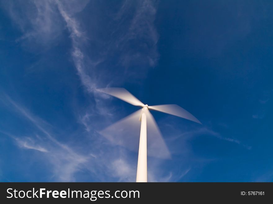 Wind turbine on a blue sky.