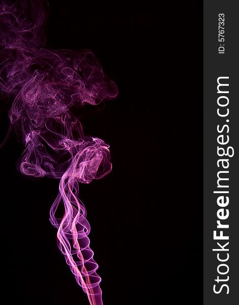 Pink smoke isolated on a black background.