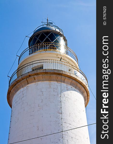 A lighthouse on a blue sky.