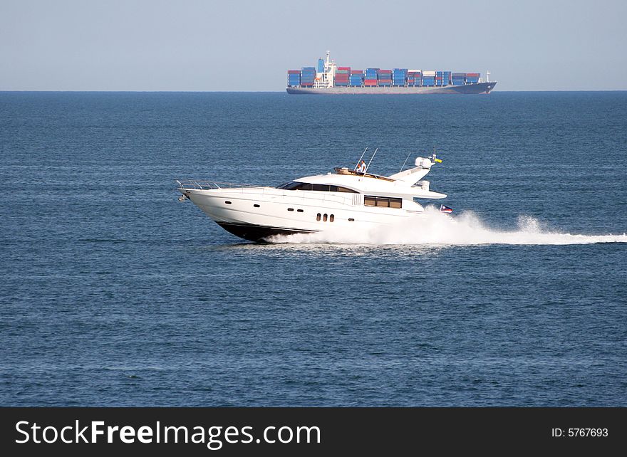 The white motor yacht rushes on the sea