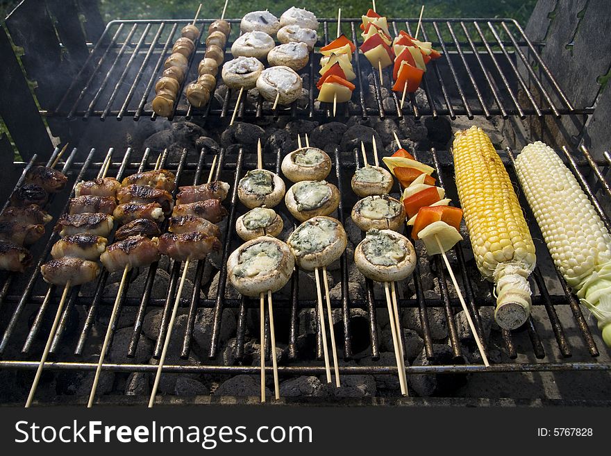 Various types of food on the barbecue.