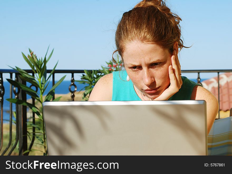 Girl sitting at the terrace with notebook. Girl sitting at the terrace with notebook