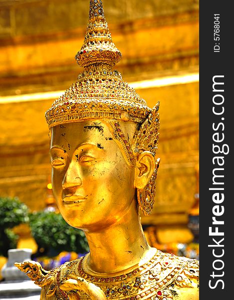 Thailand Bangkok; the wat Phra Kaew shelter the most sacred image of Thailand the Emerald Buddha. The temple is situated in the northeast corner of the Grand Palace. Decorated walls and a golden kannari. Thailand Bangkok; the wat Phra Kaew shelter the most sacred image of Thailand the Emerald Buddha. The temple is situated in the northeast corner of the Grand Palace. Decorated walls and a golden kannari