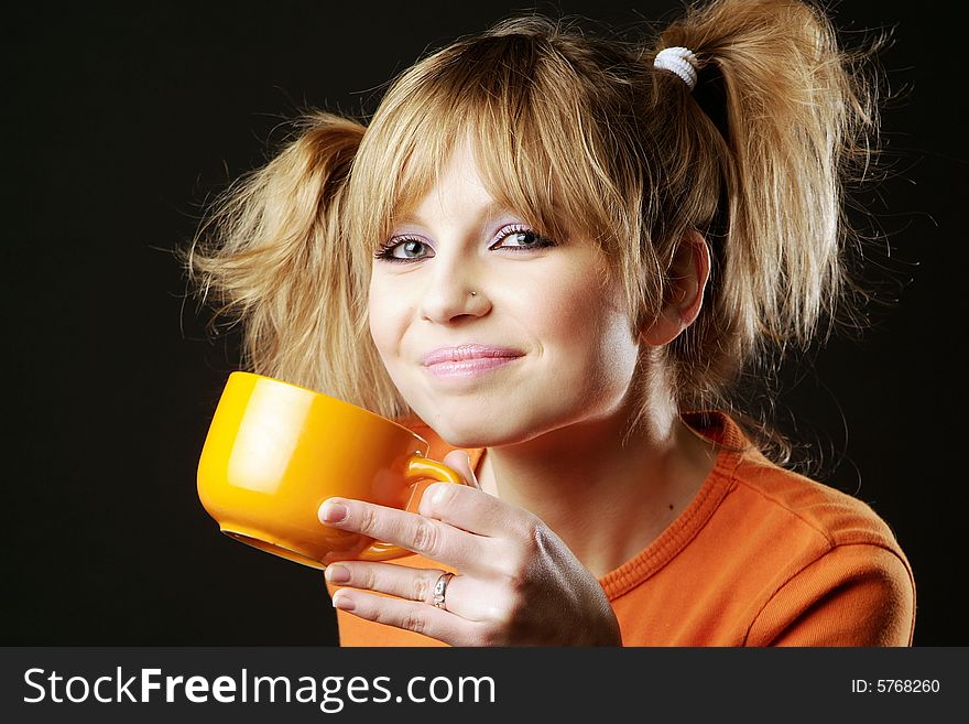 Drinking girl with a orange mug