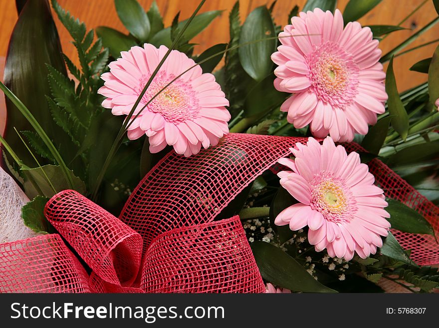 Three pink gerberas arranged in a bouquet