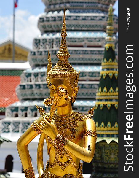 Thailand Bangkok; the wat Phra Kaew shelter the most sacred image of Thailand the Emerald Buddha. The temple is situated in the northeast corner of the Grand Palace. Decorated walls and a golden kannari. Thailand Bangkok; the wat Phra Kaew shelter the most sacred image of Thailand the Emerald Buddha. The temple is situated in the northeast corner of the Grand Palace. Decorated walls and a golden kannari