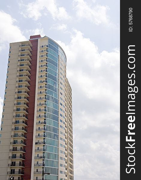 A colorful high rise condo complex against a cloudy sky. A colorful high rise condo complex against a cloudy sky