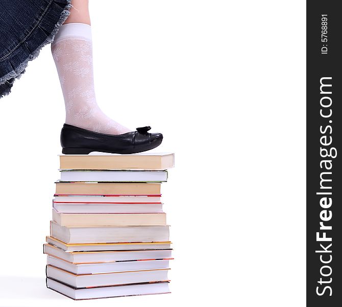Leg of litlle  girl on the stack of books. Leg of litlle  girl on the stack of books