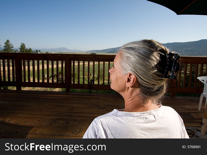 Senior Woman Sitting By Pool