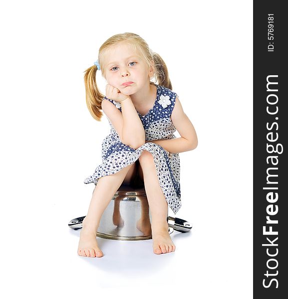 Little cute girl sitting over saucepan isolated