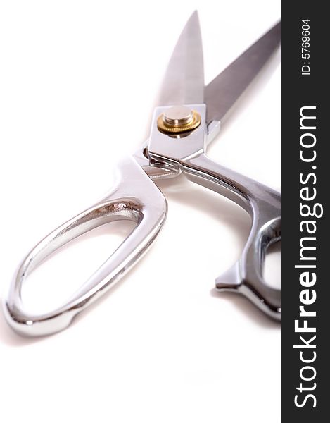 A pair of chrome dress shears or ceremonial scissors on a white background. A pair of chrome dress shears or ceremonial scissors on a white background
