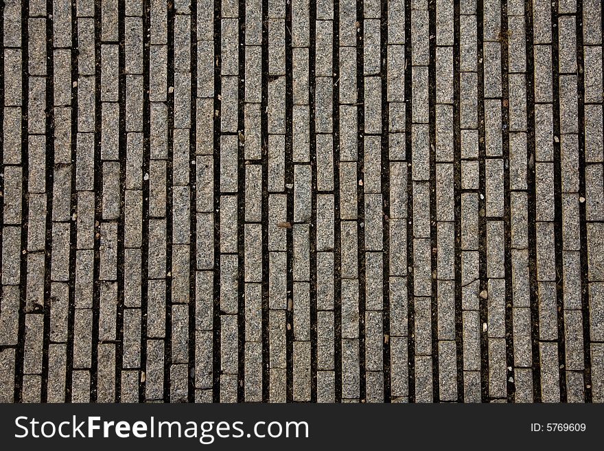 Stone design in Prague sidewalk. Background texture.