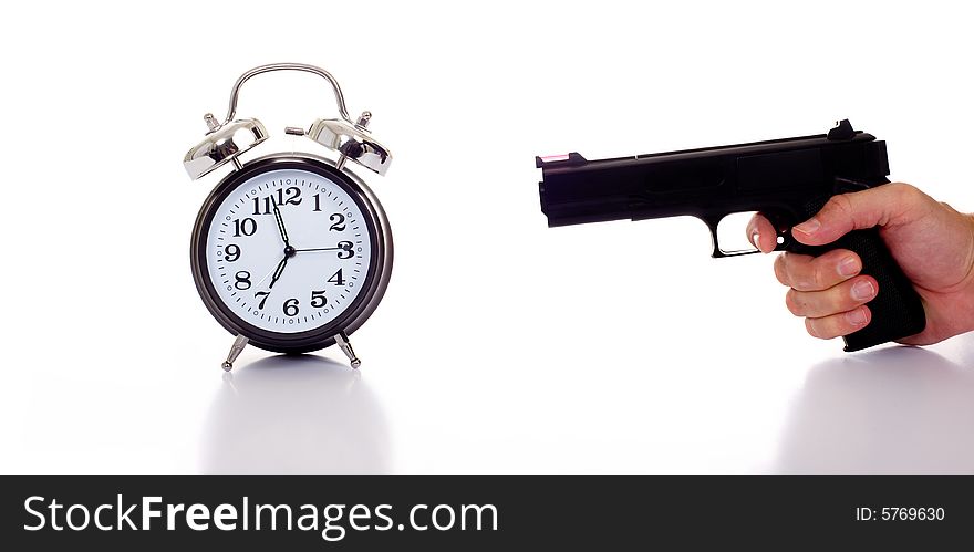 A black vintage looking Alarm clock with a person or man holding a gun to it. Stressed by time. A black vintage looking Alarm clock with a person or man holding a gun to it. Stressed by time