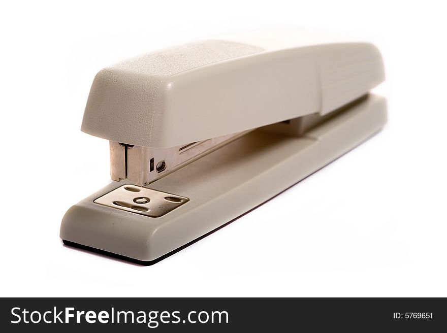 A brown office stapler on a white background with copy space. A brown office stapler on a white background with copy space