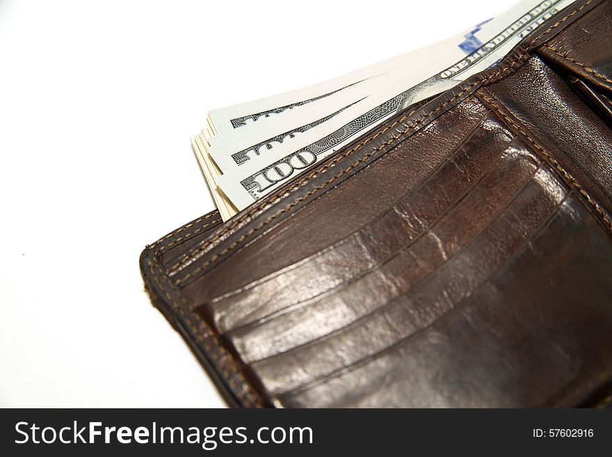 Old leather wallet with banknotes of US dollars inside