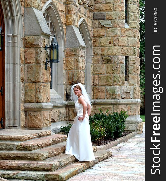 Full length view of bride walking up stone steps. Full length view of bride walking up stone steps