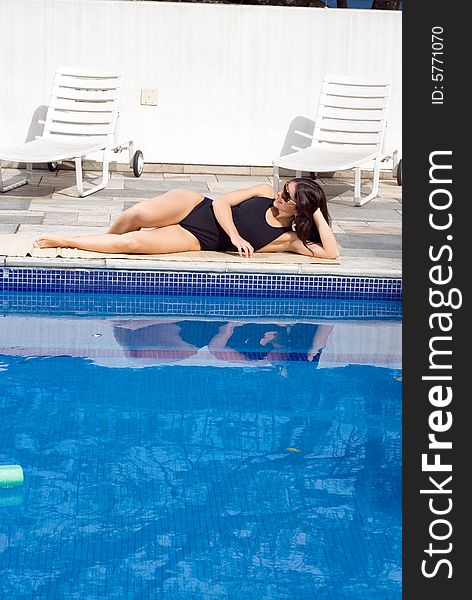 Woman Lying By Pool - Vertical