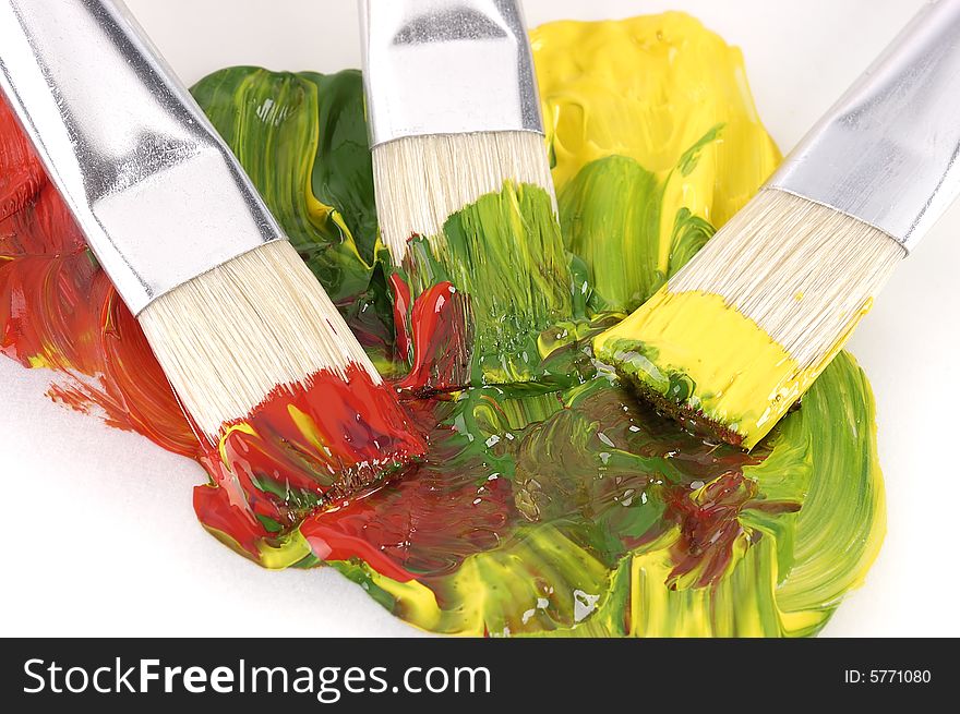 Three paintbrush on wet paint on a white background. Three paintbrush on wet paint on a white background