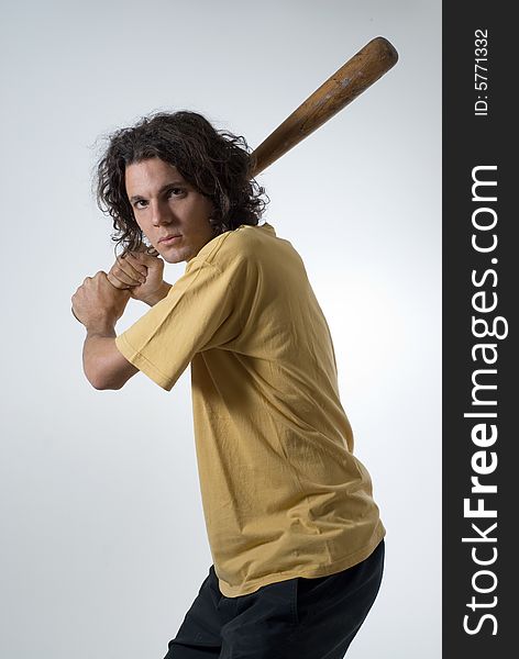 Man with an angry expression holds a baseball bat. Vertically framed photograph. Man with an angry expression holds a baseball bat. Vertically framed photograph