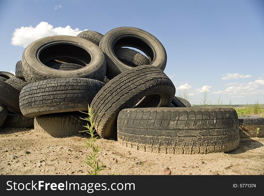 A lot of Wheel Tires dumped in a landfill. A lot of Wheel Tires dumped in a landfill.