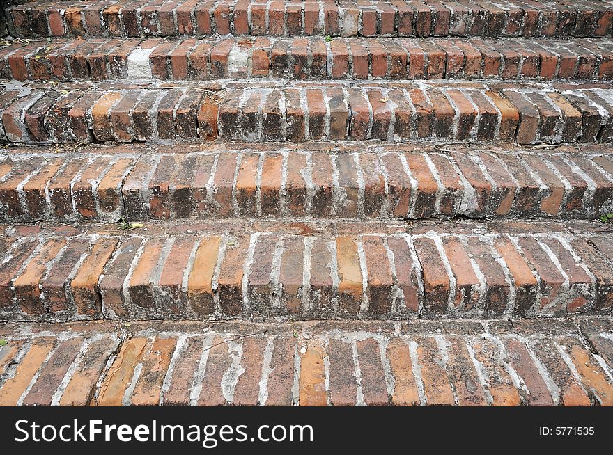 Old hand made red brick stairs