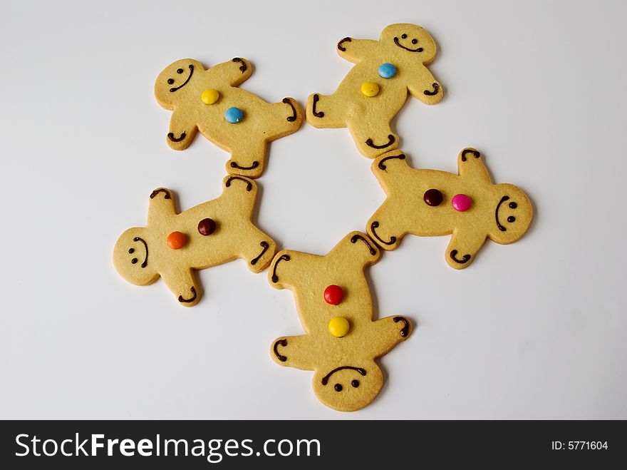 A group of shortbread men are syncronised and working as a group. A group of shortbread men are syncronised and working as a group