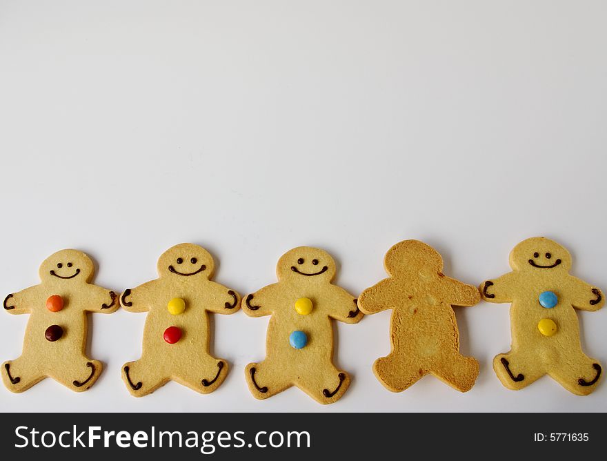 A row of shortbread men is joined by an indifferent one