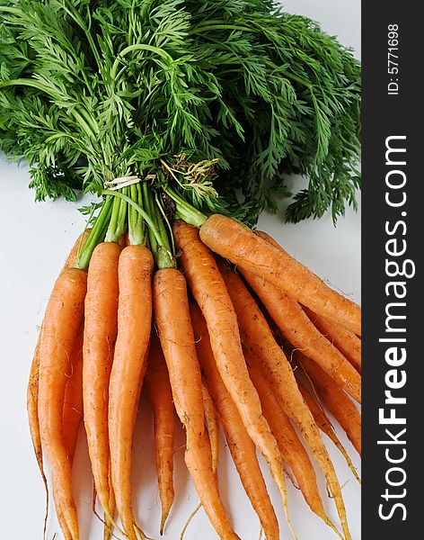 A bunch of carrots await washing and cooking. A bunch of carrots await washing and cooking