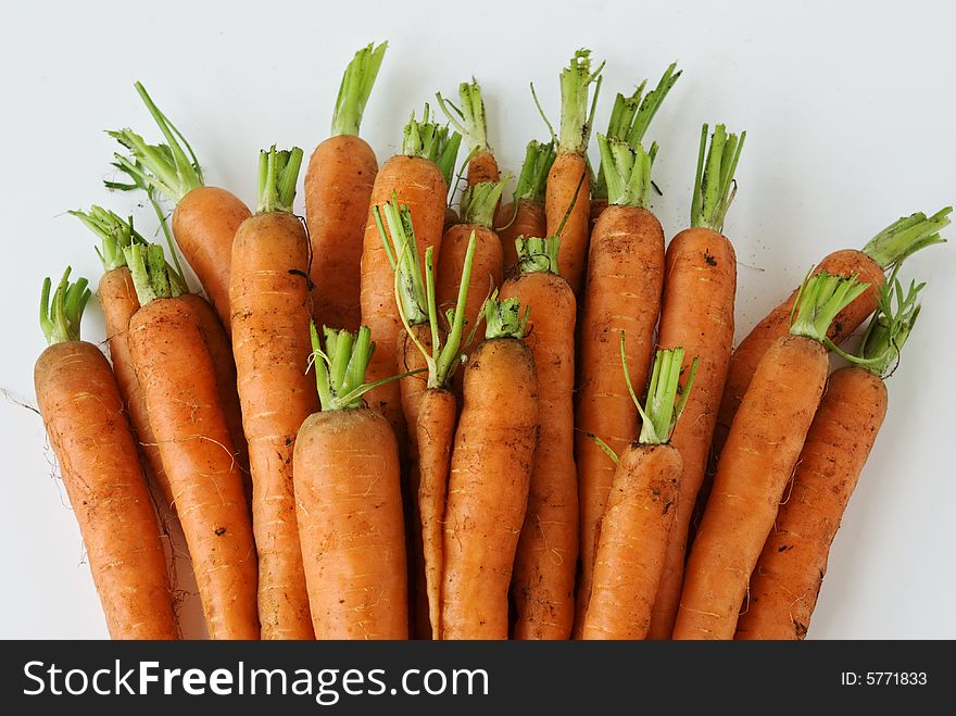 A bunch of carrots await washing and cooking. A bunch of carrots await washing and cooking