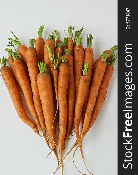 A bunch of carrots await washing and cooking. A bunch of carrots await washing and cooking