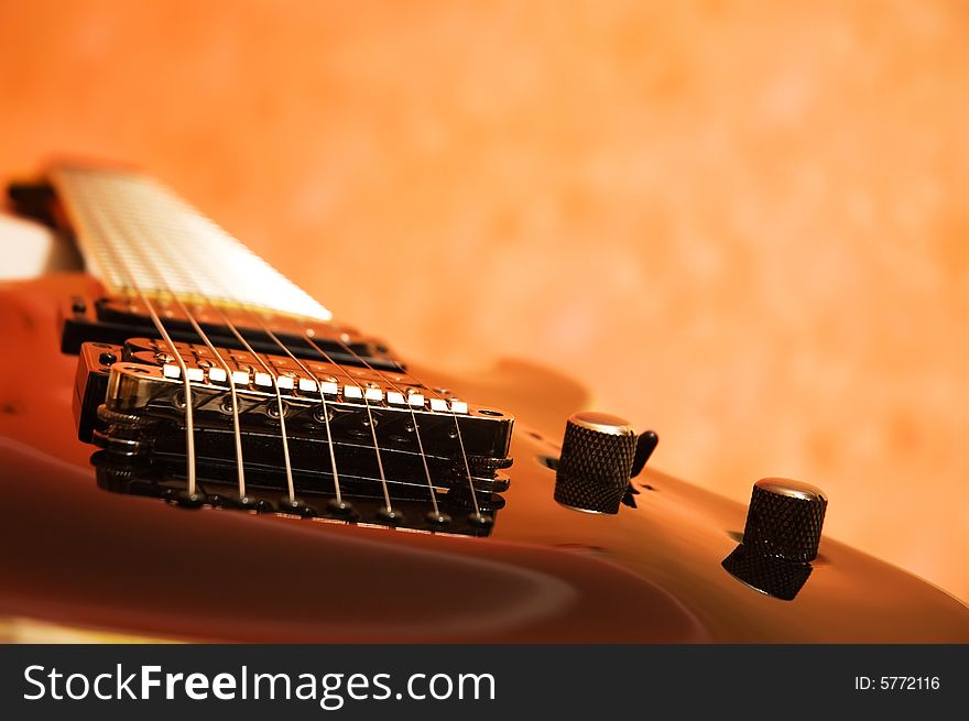 Close-up of the black electric guitar (shallow dof)