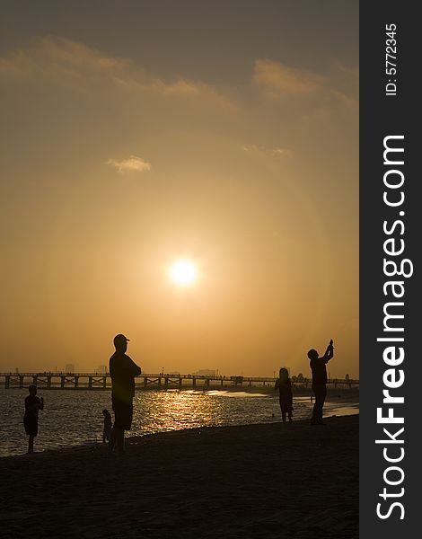 Seal Beach Sunset with silhouetted people. Seal Beach Sunset with silhouetted people.