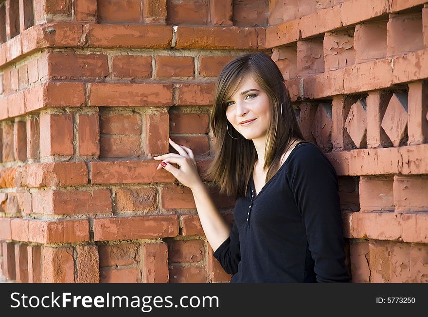 Happy Girl Against Brick Wall