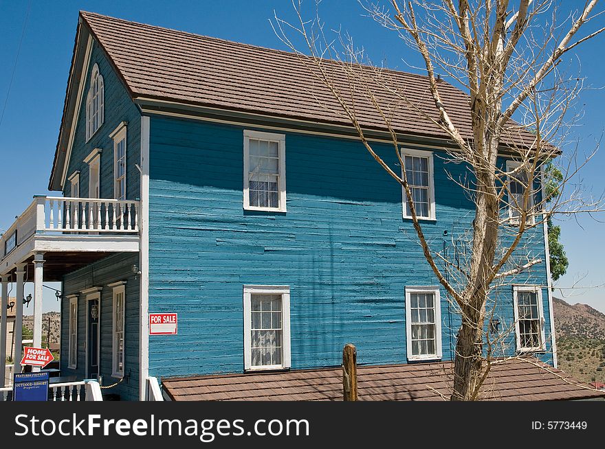 For Sale sign on old wooden home in Nevada