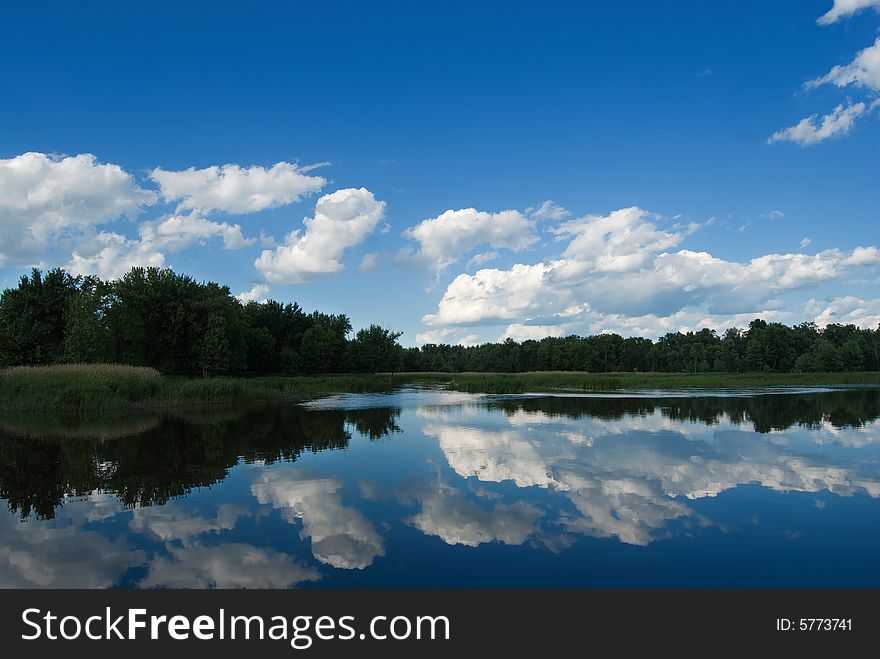 Tree's and cloud's reflecting off the waters surface. Tree's and cloud's reflecting off the waters surface