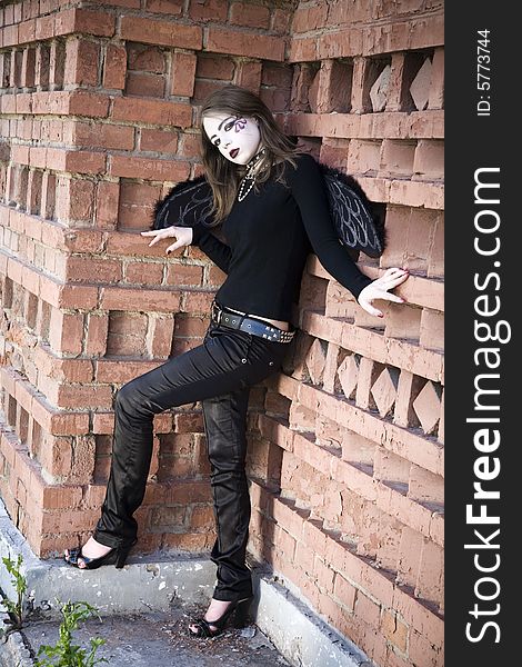 Gothic Young Woman On The Wall Background. Gothic Young Woman On The Wall Background