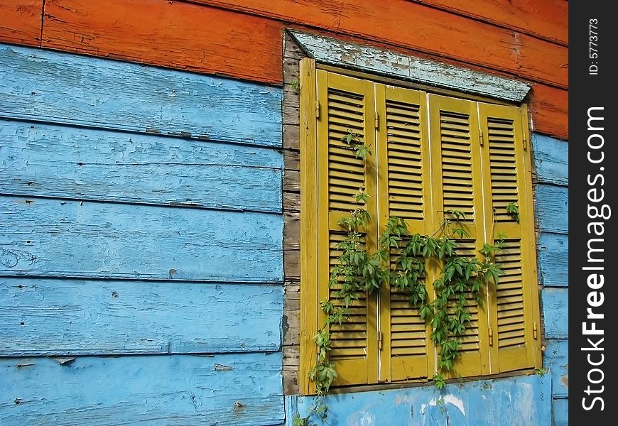 Yellow old house window in wood wall. Yellow old house window in wood wall.