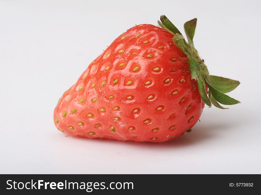 An appetizing strawberry on a white scoop