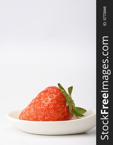 An appetizing strawberry on a white scoop