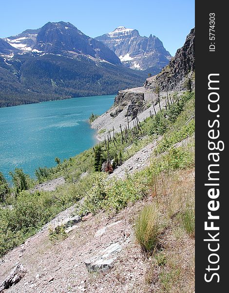 Landscapes of snow mountains, lake and sandy cliff in glacier national park, montana, usa. Landscapes of snow mountains, lake and sandy cliff in glacier national park, montana, usa