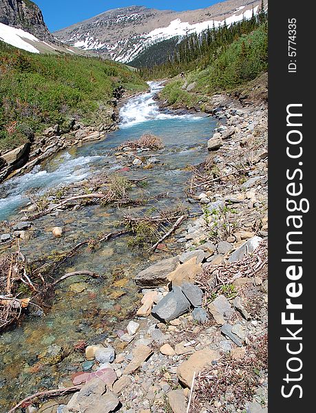 Snow mountain and hillside creek in glacier national park, montana, usa. Snow mountain and hillside creek in glacier national park, montana, usa