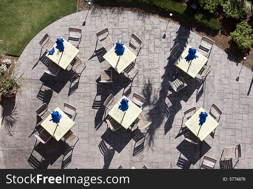 Six sets of tables and chairs on a patio. Six sets of tables and chairs on a patio